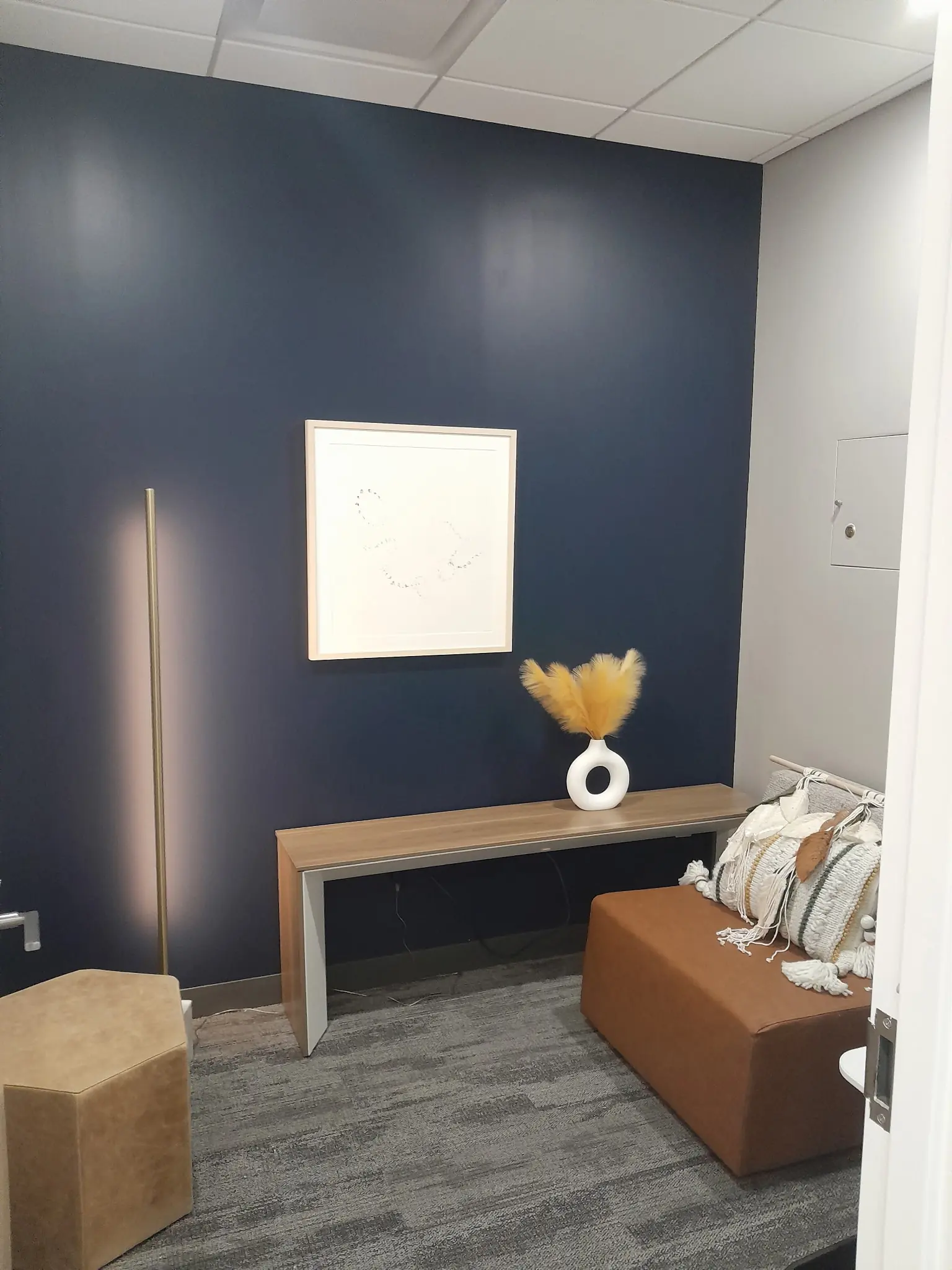 Accent wall lounge area with finished paint and millwork.