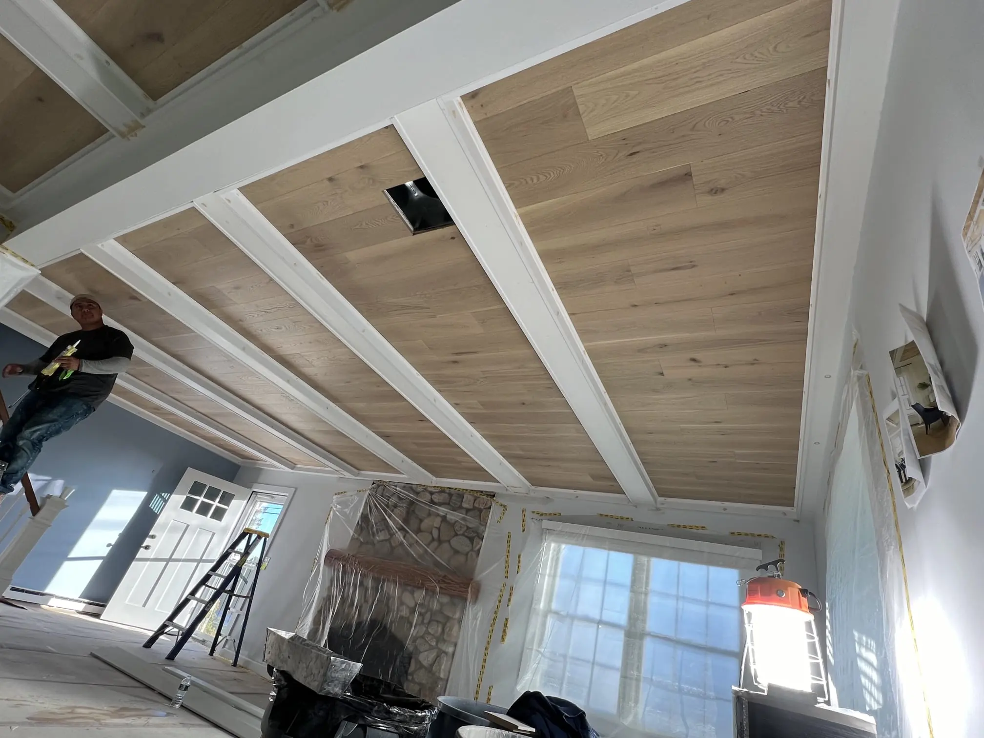 Ceiling beam and panel detail during installation.
