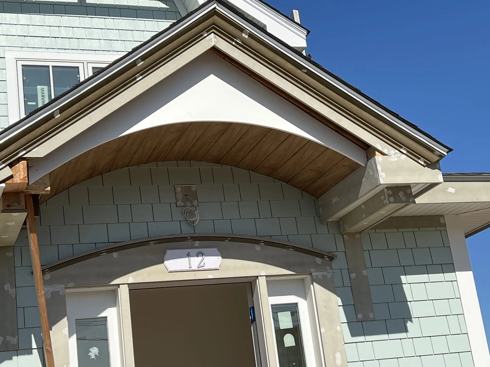 Finished hallway with trim, doors, and flooring.
