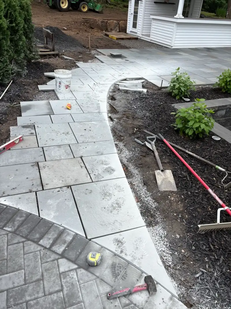 Curved paver walkway installation in progress by Pandora Group LLC.