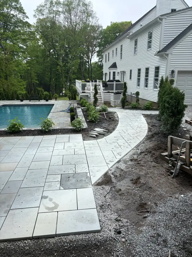 Pool terrace paving and garden wall masonry by Pandora Group LLC.
