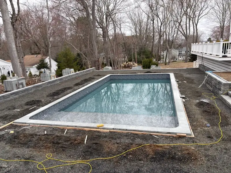 Pool shell and retaining wall masonry under construction by Pandora Group LLC.
