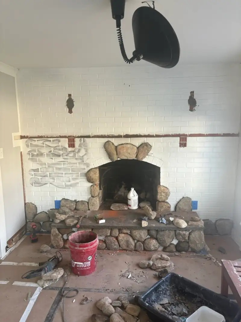 Stone fireplace installation in progress by Pandora Group LLC.